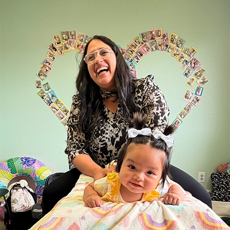 Nicole Mercado Adjusting A Happy Infant Patient
