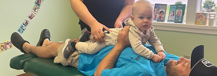 Chiropractor Nicole Mercado With Patient And Dad