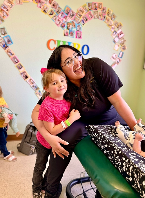 Chiropractor Nicole Mercado With Young Patients Smiling